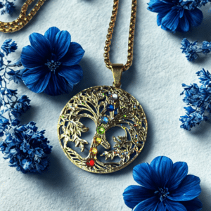 Collier Arbre de Lumière doré Harmonie des Énergies 7 chakras posé sur marbre