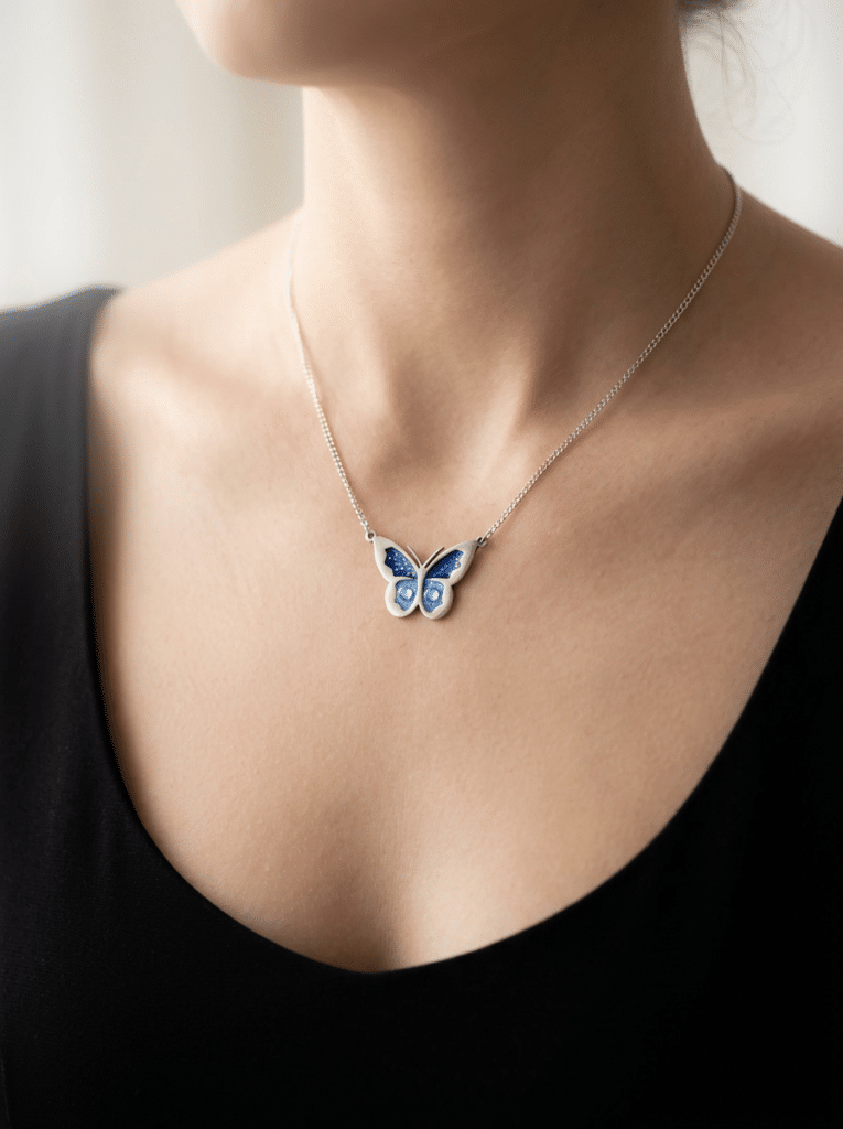 Collier Papillon Éternel bleu pailleté Aile Céleste finition argentée porté au cou